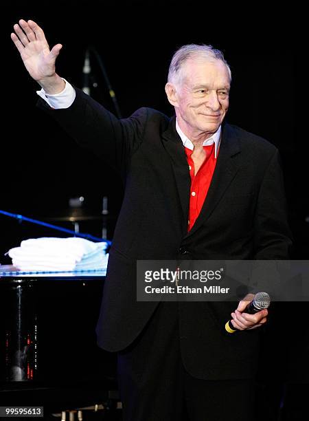 Playboy founder Hugh Hefner waves at a party introducing model Hope Dworaczyk as the 2010 Playboy Playmate of the Year at the Rain Nightclub inside...