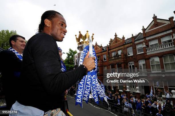 Didier Drogba of Chelsea poses with the Premier League trophy during the Chelsea Football Club Victory Parade on May 16, 2010 in London, England.