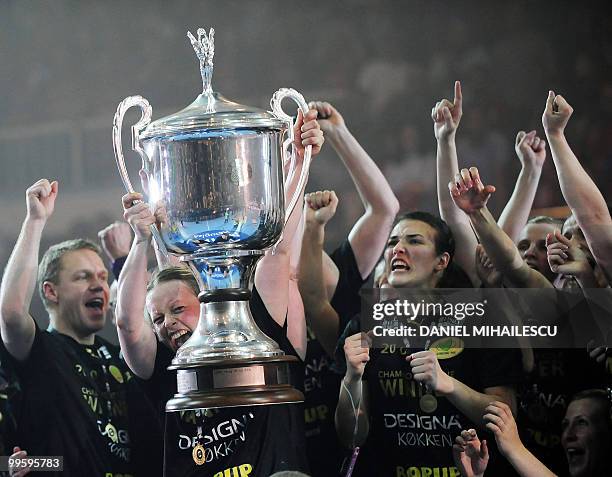 Female members of the Viborg team celebrate their victory as they hold the EHF Champions League Trophy after they defeated Oltchim Ramnicu Valcea...