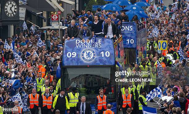 Members of the Chelsea football squad led by John Terry parade through the streets of west London on May 16, 2010 as they celebrate winning the...