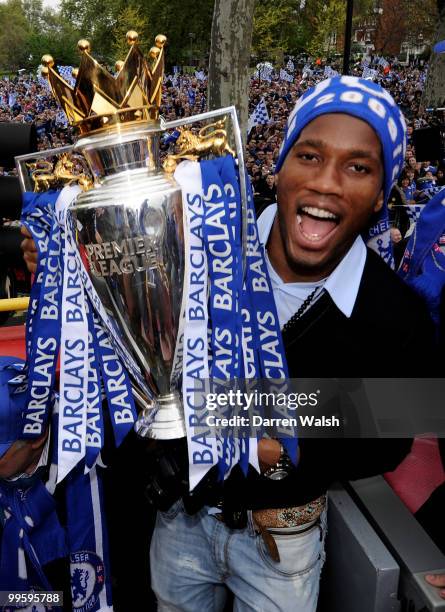 Didier Drogba of Chelsea poses with the Premier League trophy during the Chelsea Football Club Victory Parade on May 16, 2010 in London, England.