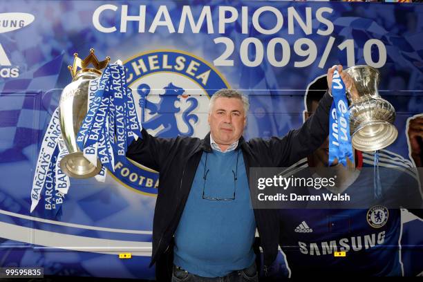 Chelsea Manager Carlo Ancelotti poses with the Premier League and FA Cup trophies prior to the Chelsea Football Club Victory Parade on May 16, 2010...