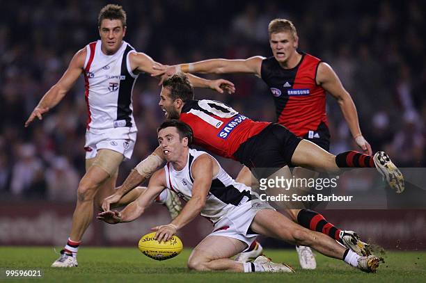 Stephen Milne of the Saints and Mark McVeigh of the Bombers compete for the ball during the round eight AFL match between the St Kilda Saints and the...