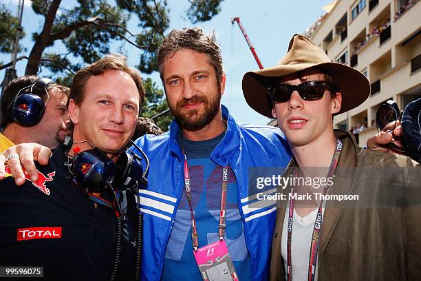 Red Bull Racing Team Principal Christian Horner meets actor Gerard Butler and Razorlight musician Johnny Borrell on the grid before the start of the...