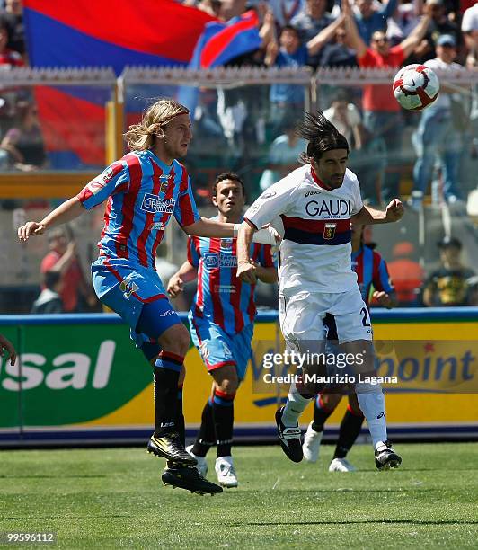 Maximiliano Maxi Lopez of Catania Calcio battles for the ball with Ivan Juric of Genoa CFC during the Serie A match between Catania Calcio and Genoa...