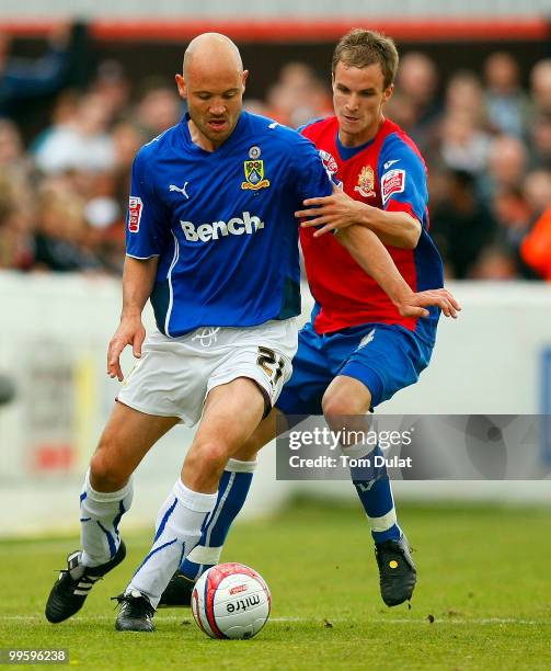 Scott Doe of Dagenham & Redbridge and Paul Mullin of Morecombe battle for the ball during the Coca Cola League Two Playoff Semi Final 1st Leg match...