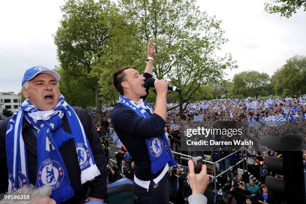 John Terry of Chelsea salutes the crowd with Manager Carlo Ancelotti during the Chelsea Football Club Victory Parade on May 16, 2010 in London,...