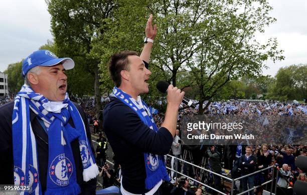 John Terry of Chelsea salutes the crowd with Manager Carlo Ancelotti during the Chelsea Football Club Victory Parade on May 16, 2010 in London,...