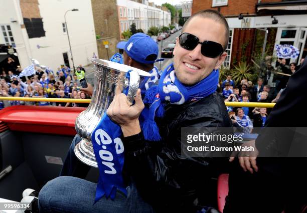 Joe Cole of Chelsea poses with the FA Cup trophy during the Chelsea Football Club Victory Parade on May 16, 2010 in London, England.