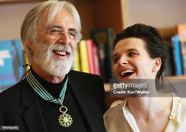 Actress Juliette Binoche poses with Austrian writer and director Michael Haneke who is awarded the Commander in the Order of Arts and Literature at...