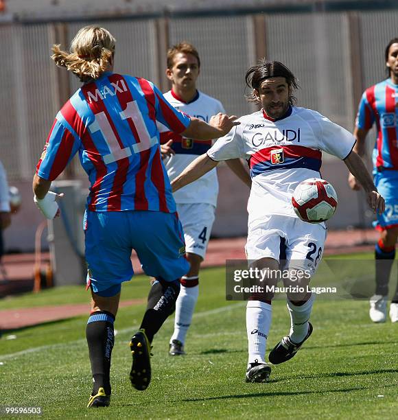 Maximiliano Maxi Lopez of Catania Calcio battles for the ball with Ivan Juric of Genoa CFC during the Serie A match between Catania Calcio and Genoa...