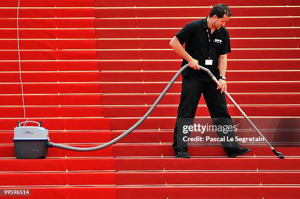 Cleaner vacuums the red carpet during the 63rd Annual Cannes Film Festival on May 16, 2010 in Cannes, France.