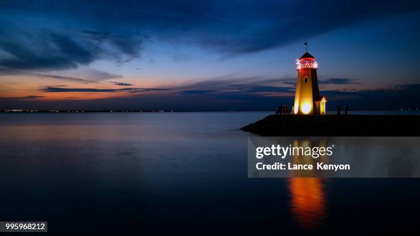 lighthouse sunset - dan kenyon stockfoto's en -beelden