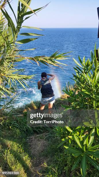 photographer makes a photo of the rainbow - duden stock-fotos und bilder