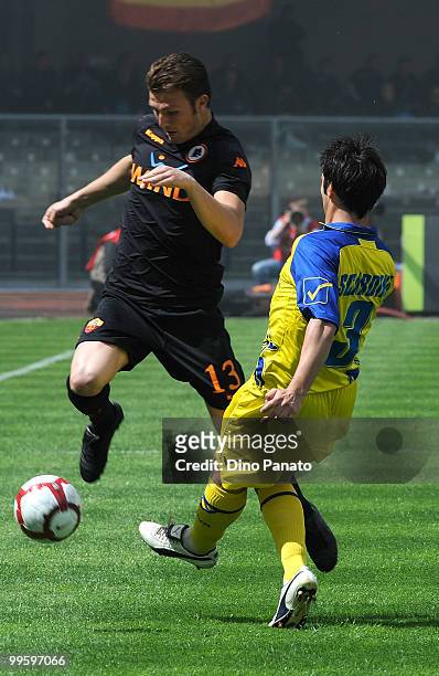 Marco Motta of Roma competes with Francesco Scardina of Chievo during the Serie A match between AC Chievo Verona and AS Roma at Stadio Marc'Antonio...