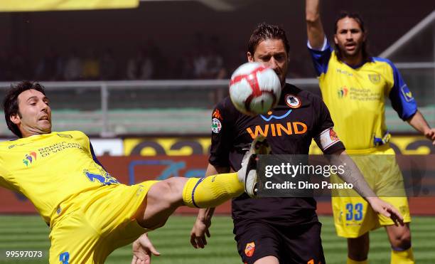 Francesco Totti of Roma competes with Francesco Scardina of Chievo during the Serie A match between AC Chievo Verona and AS Roma at Stadio...