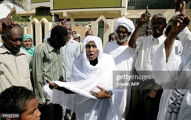 Wissal Mahdi Turabi, wife of arrested Islamist opposition leader Hassan al-Turabi, joins her husband's supporters as they shout slogans against his...