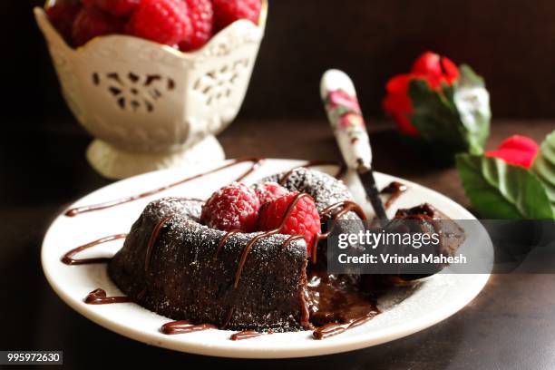 molten lava cake / chocolate lava cake - lava cake stock pictures, royalty-free photos & images