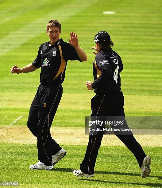 Chris Woakes of Warwickshire is congratulated by Ian Bell on the wicket of Azhar Mahmood of Kent, after he was caught by Tim Ambrose during the...