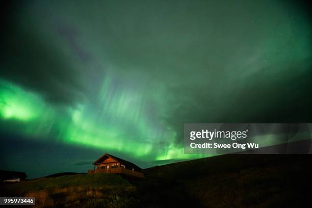 aurora over lone house - wu swee ong stock pictures, royalty-free photos & images