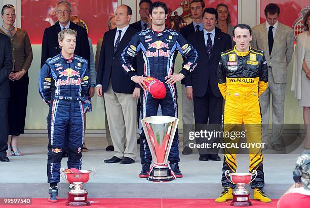 Red Bull's German driver Sebastian Vettel, Red Bull's Australian driver Mark Webber and Renault f1's Polish driver Robert Kubica stand in the podium...