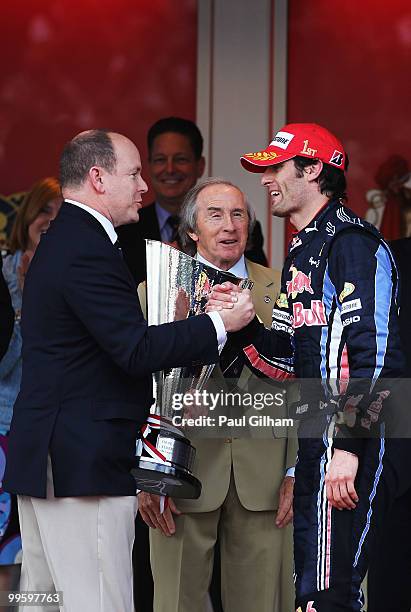 Mark Webber of Australia and Red Bull Racing is congratulated by Prince Albert II of Monaco and Jackie Stewart after winning the Monaco Formula One...