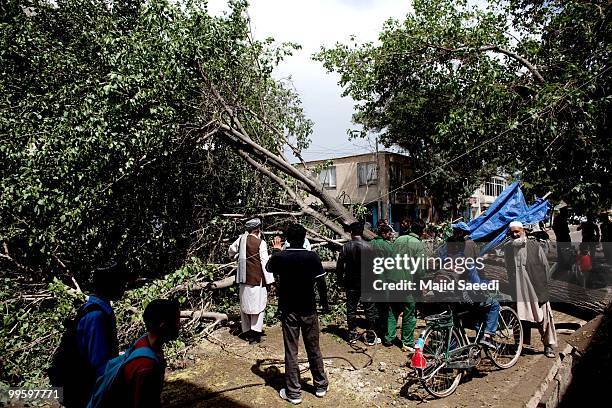 People survey the damage a severe storm caused on one of the main streets on May 16, 2010 in Kabul, Afghanistan. The storm caused power outages in...