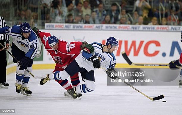 Pavel Patera of the Czech Republic challenges Petteri Nummelin of Finland for the puck during the IIHF World Ice Hockey Championship Final in the...
