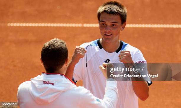 Andreas Beck of Germany celebrates after winning his match against Paul-Henri Mathieu of France with national coach Patrick Kuehnen during day one of...