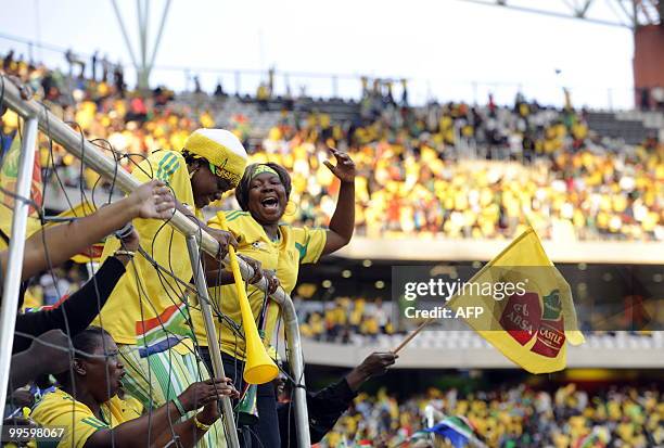 Supporters of South African national football team cheer up on May 16, 2010 at the Mbombela Stadium in Nelspruit during the international friendly...