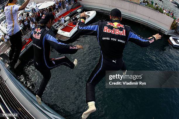 Race winner Mark Webber of Australia and Red Bull Racing celebrates with second placed team mate Sebastian Vettel of Germany and Red Bull Racing by...
