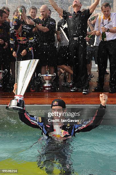 Red Bull's Australian Driver Mark Webber celebrates in the pool after winning the Monaco Grand Prix 2010 at the Red Bull Formula 1 Energy Station on...