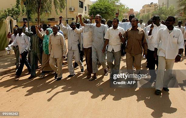 Supporters of Sudanese Islamist opposition leader Hassan al-Turabi shout slogans against his arrest as they march in Khartoum on their way to his...