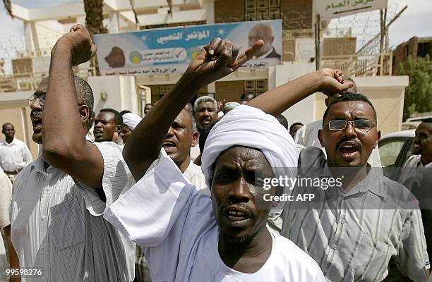 Supporters of Sudanese Islamist opposition leader Hassan al-Turabi shout slogans against his arrest as they march in Khartoum on their way to his...