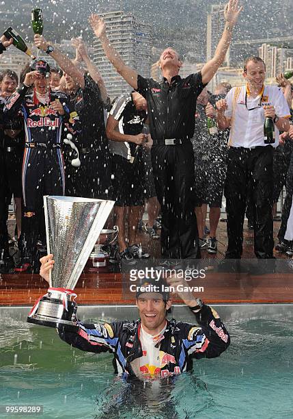 Red Bull's Australian Driver Mark Webber celebrates in the pool after winning the Monaco Grand Prix 2010 at the Red Bull Formula 1 Energy Station on...