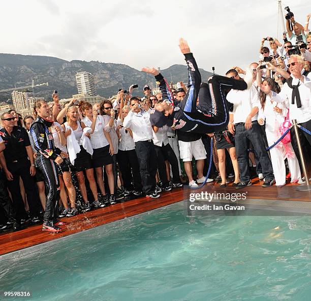 Red Bull's Australian Driver Mark Webber celebrates in the pool after winning the Monaco Grand Prix 2010 at the Red Bull Formula 1 Energy Station on...