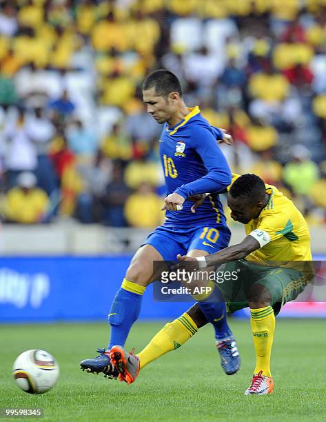 South Africa's captain Teko Modise fights for the ball with Varonchai Narongchai of Thailand during their international friendly football match at...