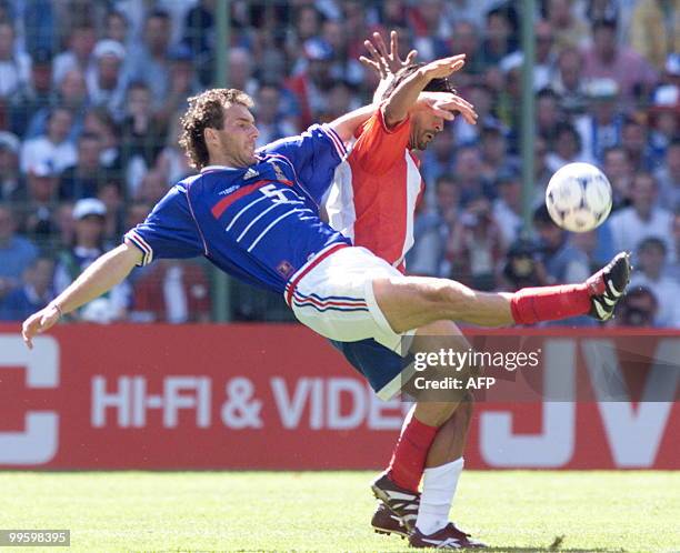 French defender Laurent Blanc fights for the ball with an unidentified Paraguayan player 28 June at the Felix Bollaert stadium in Lens, northern...