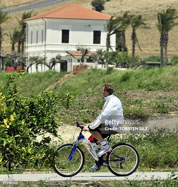 Germany's goalkeeper Manuel Neuer cycles a bike at the Verdura Golf and Spa resort, near Sciacca May 16, 2010. The German team is currently taking...