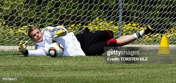 Germany's goalkeeper Manuel Neuer makes a save during a training session at the Verdura Golf and Spa resort, near Sciacca May 16, 2010. The German...