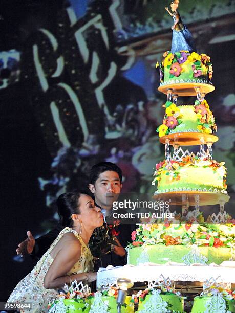 Dionesia Pacquiao, mother of Philippine boxing superstar Manny Pacquiao , blows a candle on a giant cake during the victory party of his son after...