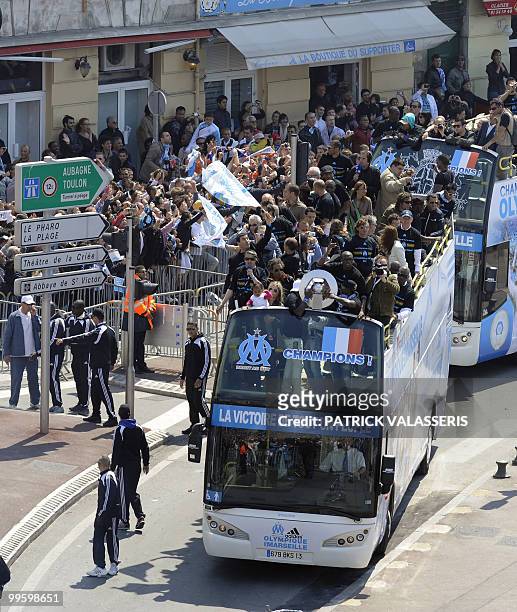Olympique de Marseille's players parade in buses following the team's victory in the French L1 football championship, on May 16, 2010 at the...