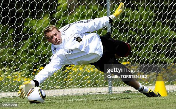 Germany's goalkeeper Manuel Neuer makes a save during a training session at the Verdura Golf and Spa resort, near Sciacca May 16, 2010. The German...