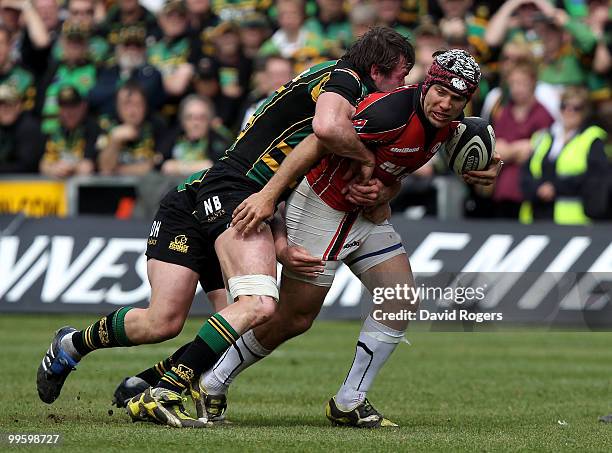 Schalk Brits of Saracens is tackled by Dylan Hartley and Neil Best during the Guinness Premiership semi final match between Northampton Saints and...