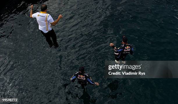 Race winner Mark Webber of Australia and Red Bull Racing celebrates with second placed team mate Sebastian Vettel of Germany and Red Bull Racing by...