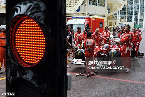 Ferrari's Spanish driver Fernando Alonso gets ready for the start of the Monaco Formula One Grand Prix in the pits of the Monaco street circuit on...