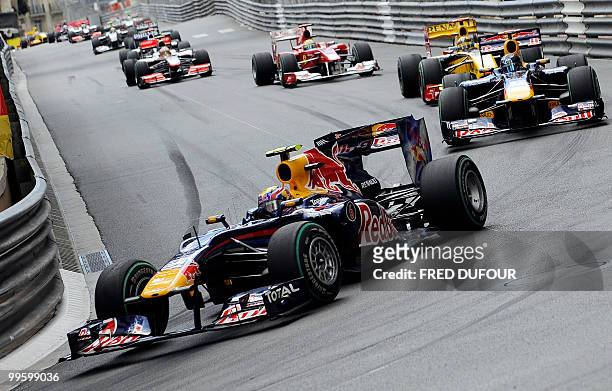 Red Bull's Australian driver Mark Webber drives ahead of Red Bull's German driver Sebastian Vettel and Renault f1's Polish driver Robert Kubica at...