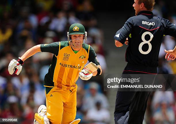 Australian batsman Michael Clarke scores a run as English bowler Stuart Broad looks on during the Men's ICC World Twenty20 final match between...