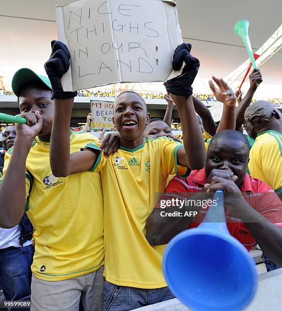 Supporters of the South African national football team blow the vuvuzela trumpets as they cheer on May 16, 2010 at the Mbombela Stadium in Nelspruit...