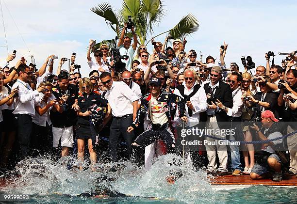 Sebastian Vettel of Germany and Red Bull Racing falls in after trying to throw race winner Mark Webber of Australia and Red Bull Racing into the Red...